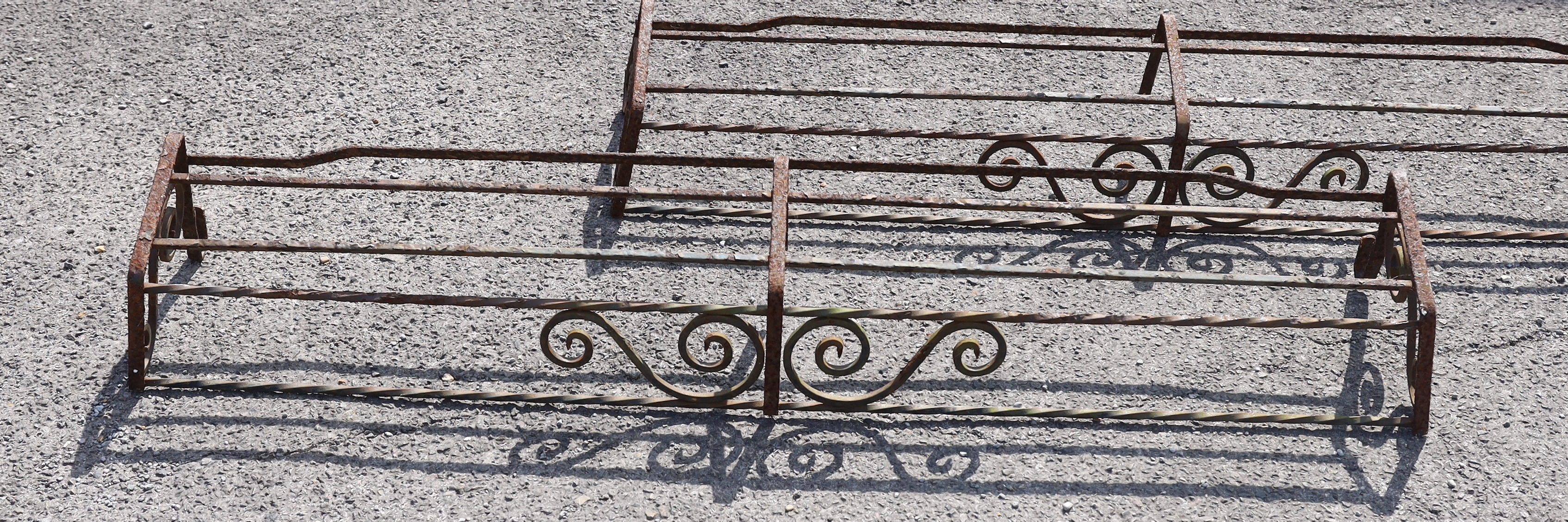 Three wrought iron pot stands and hangers, largest width 140cm
